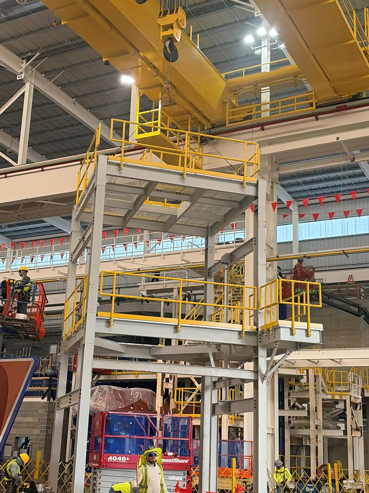 Steel VIM structure with handrail being set inside a plant beneath an overhead crane