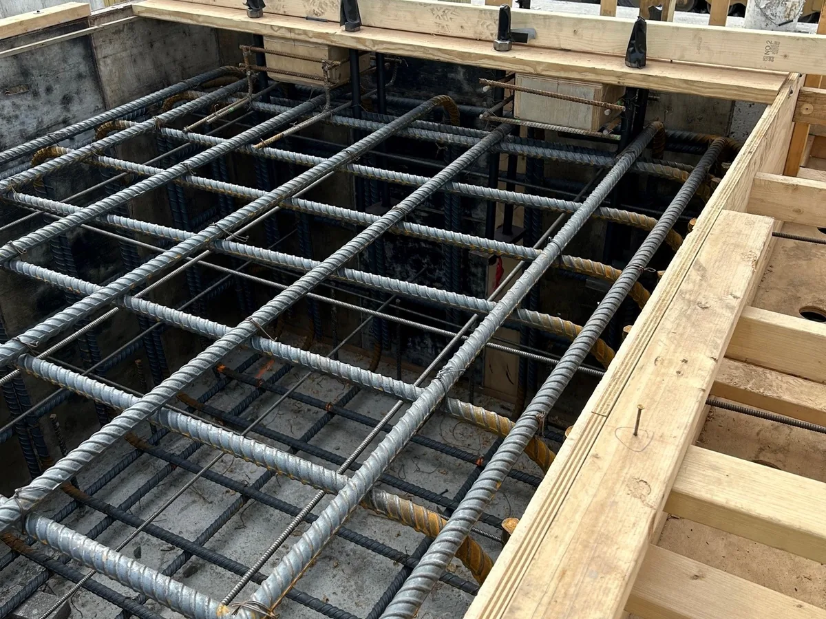 Reinforcing mat and cage tied inside the formwork for a heavy foundation