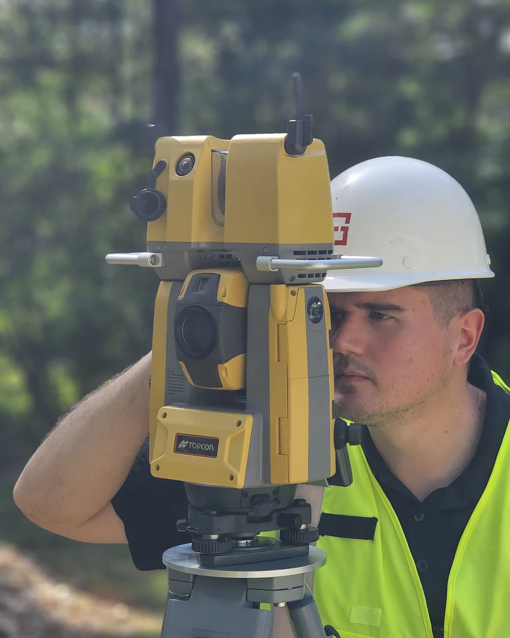 GIP technician sighting a total station on site