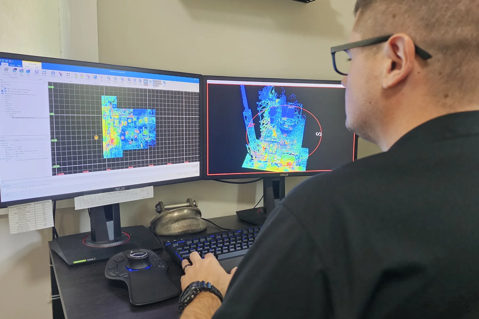 Engineer registering a colorized point cloud on dual monitors