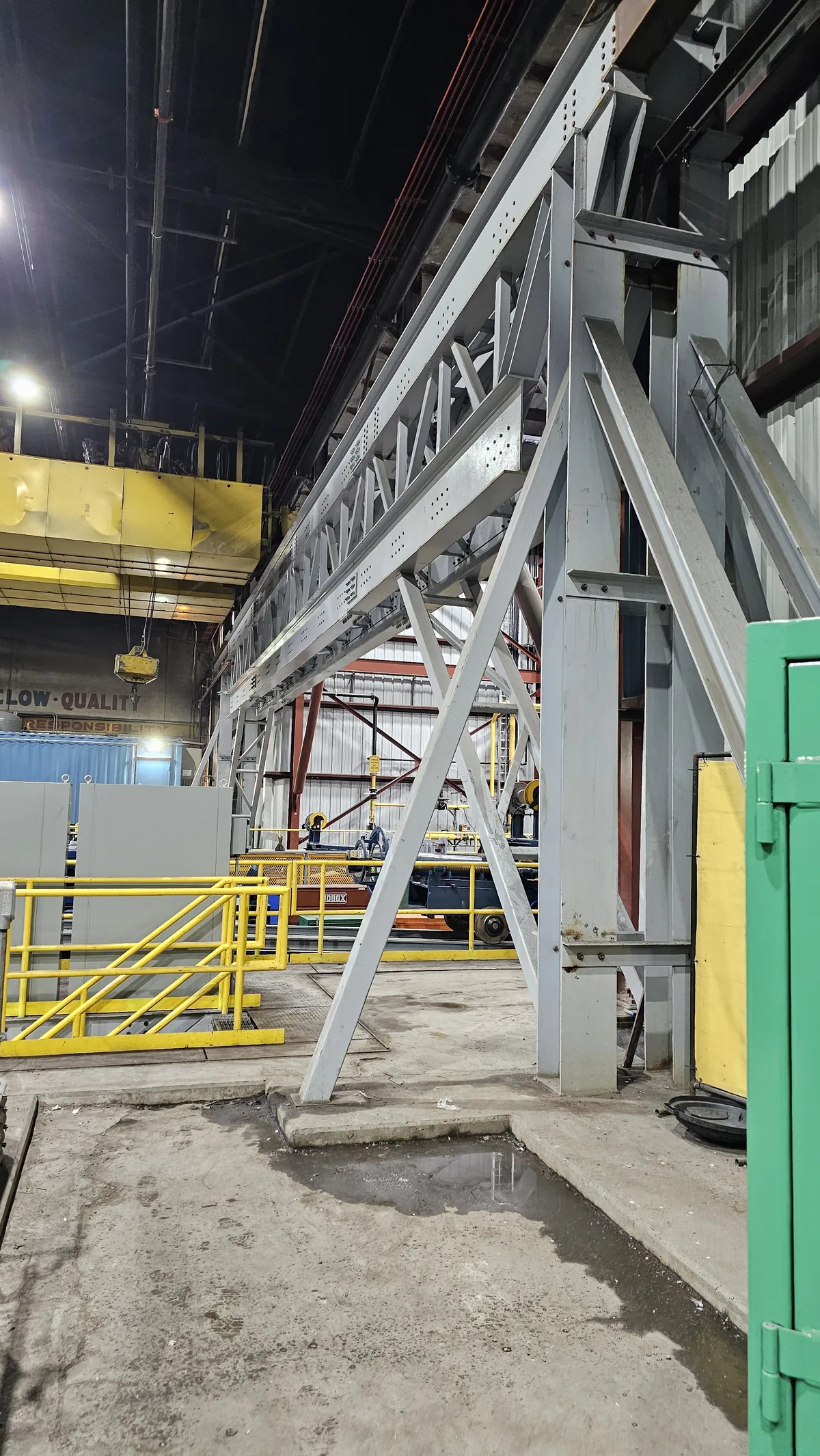 Braced steel support frame with handrail installed on the plant floor